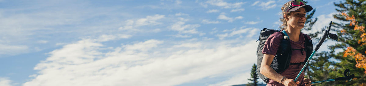 Woman using running poles on an outdoor adventure run