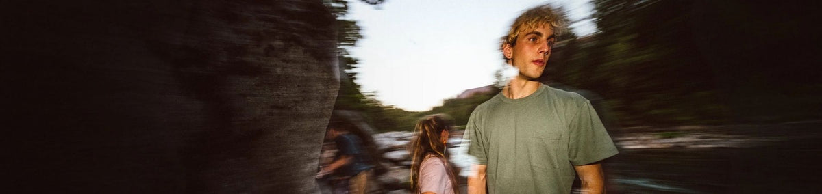 Artistic shot of a man in a green shirt outside