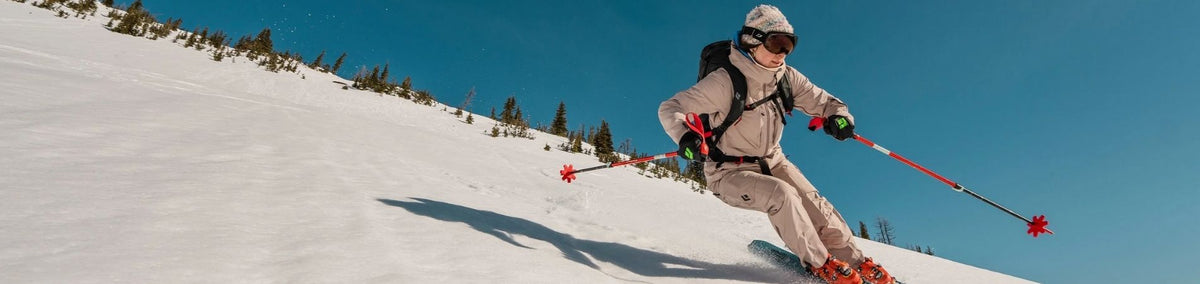 Person in complete ski gear skiing down hill