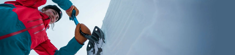 Person carefully shovelling away snow to clear path