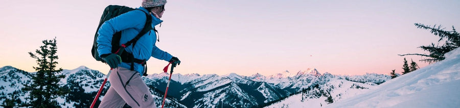 Woman trekking in the snow in complete snow gear