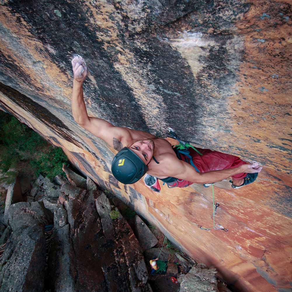 Kyle Meredith-Peck climbing outdoors wearing a Black Diamond Vapor helmet